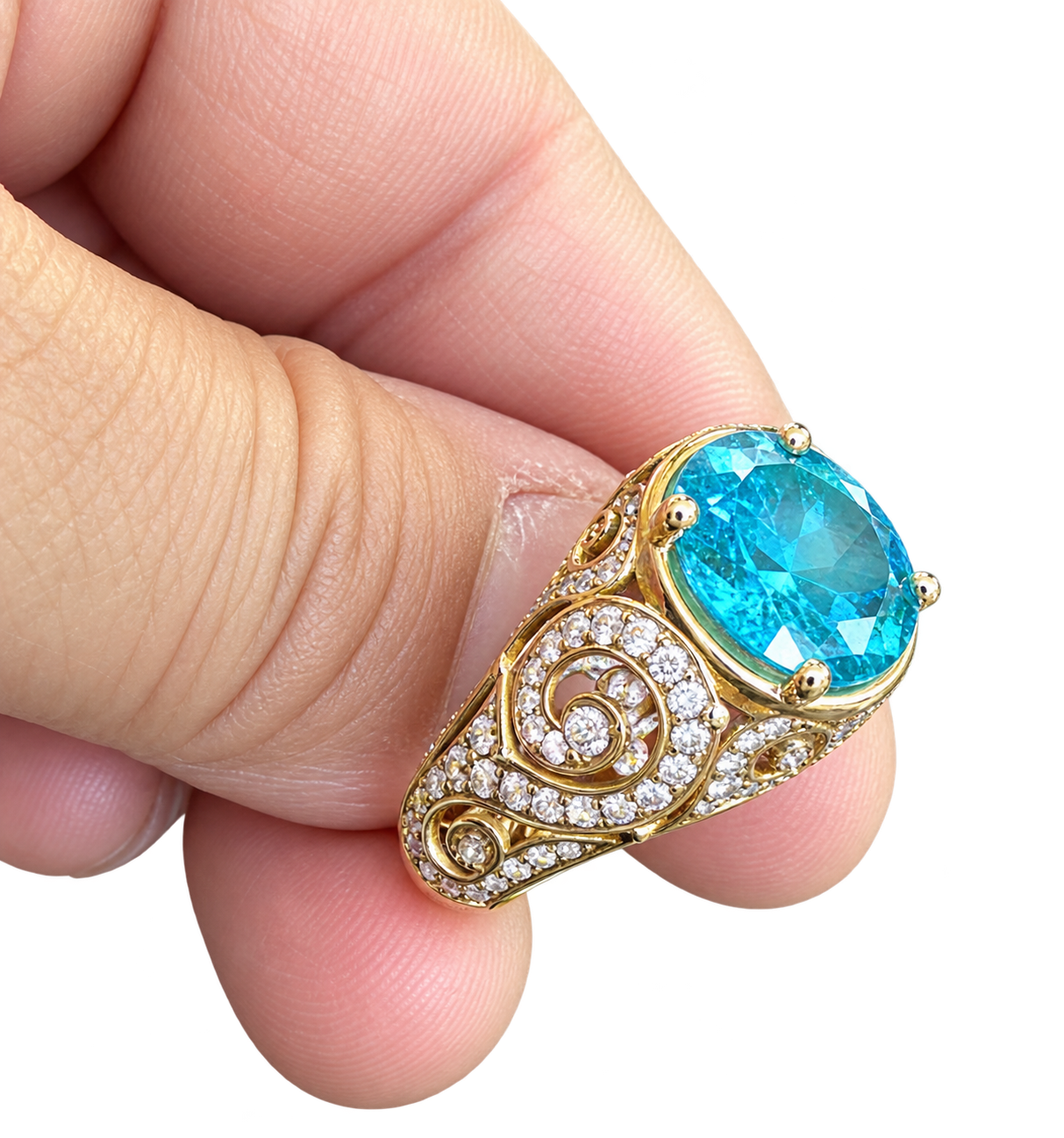 Hand presenting a gold ring with a blue aquamarine gemstone