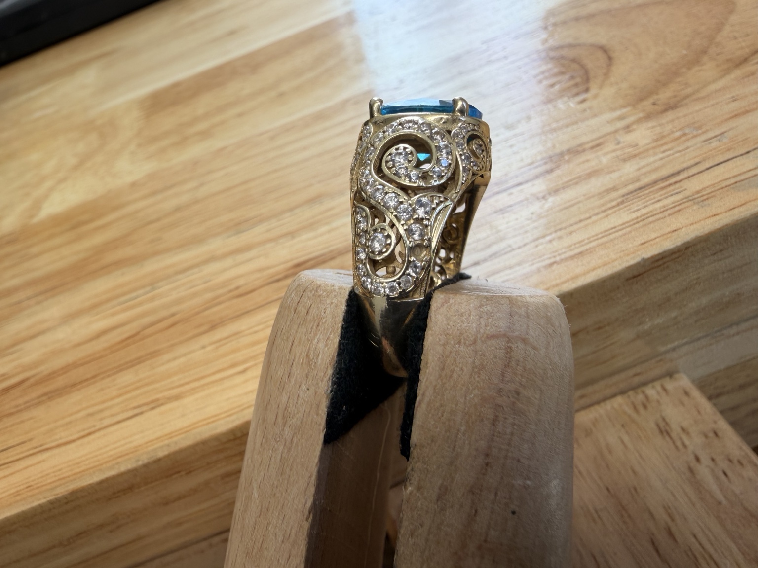 Finished ring held in a wooden jeweler’s tool